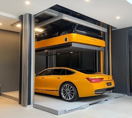 Car parking lift raising a car onto a stacked parking platform in a garage