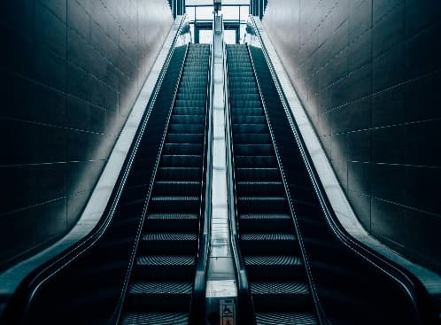 Escalators rising through a modern transit station