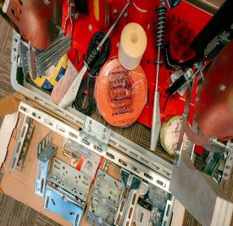 Genuine elevator spare parts and components laid out in a service kit